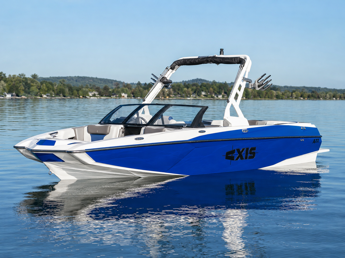 2018 Axis A22 wake boat floating on calm lake water
