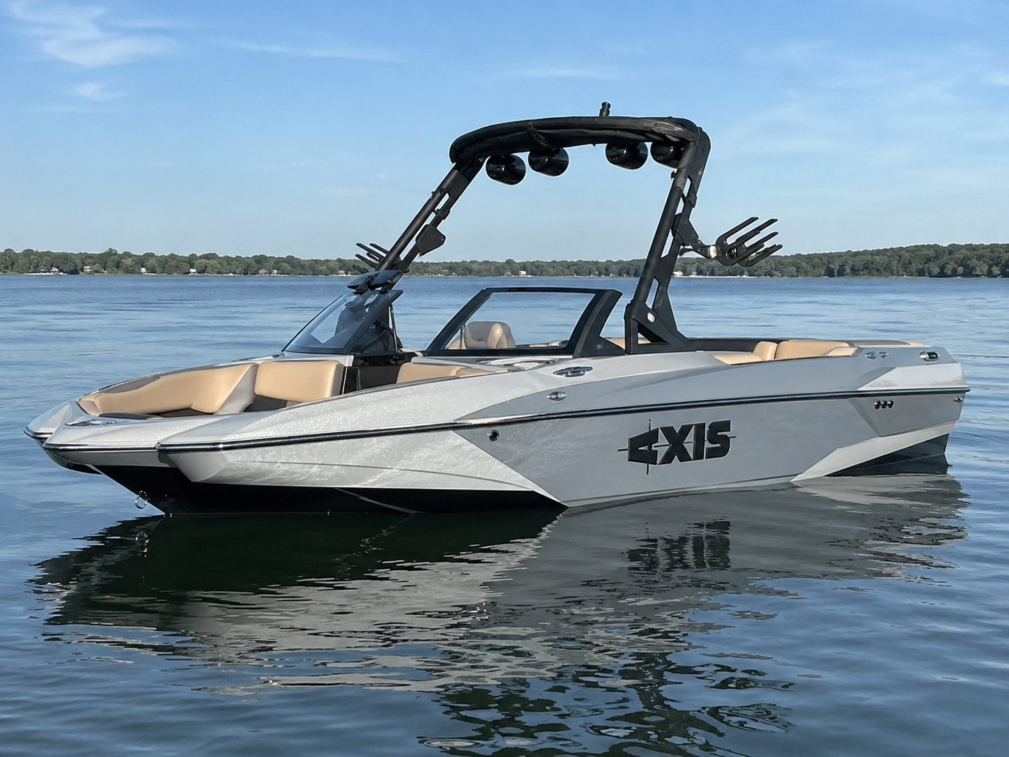 2021 Axis A24 wakesurf boat floating on calm lake water