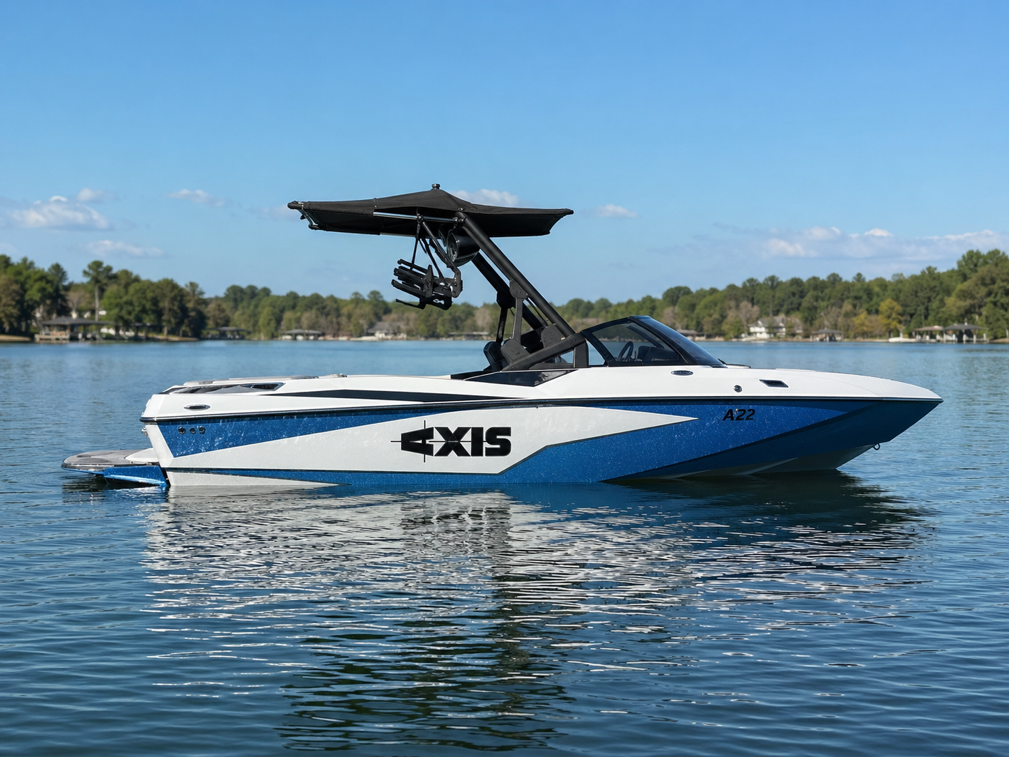 2022 Axis A22 floating on calm lake water, clean side profile, sunny day