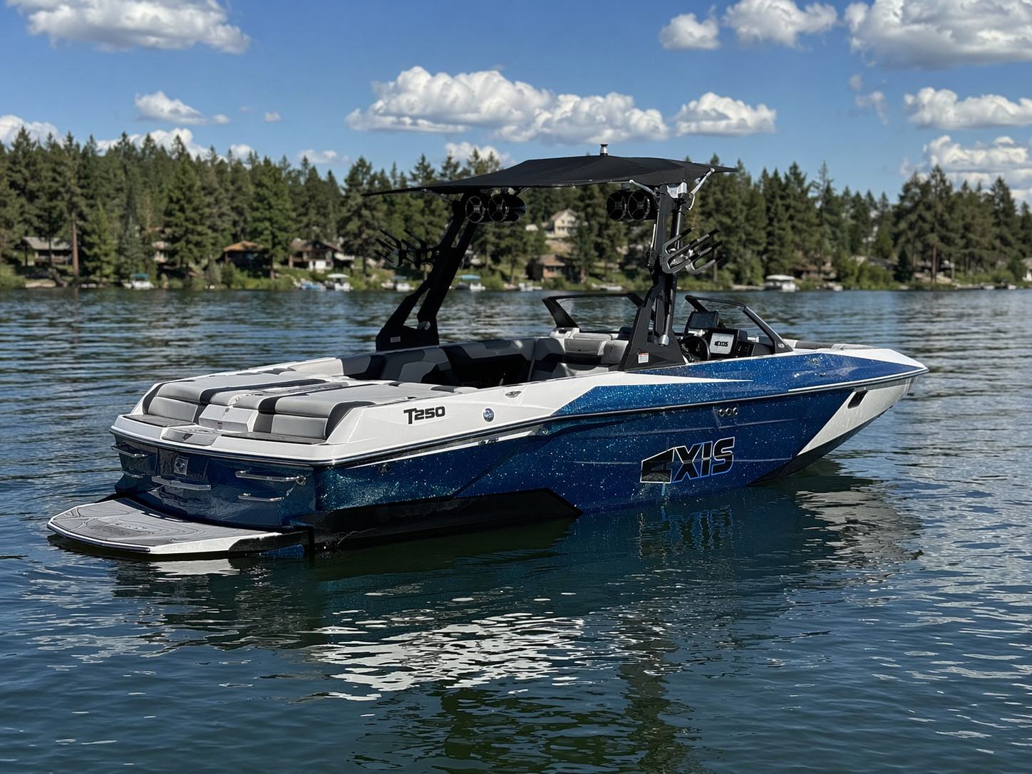 2022 Axis T250 wakesurf boat floating on calm lake water